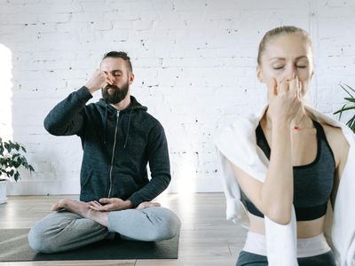 Person breathing deeply in a bright, airy room.